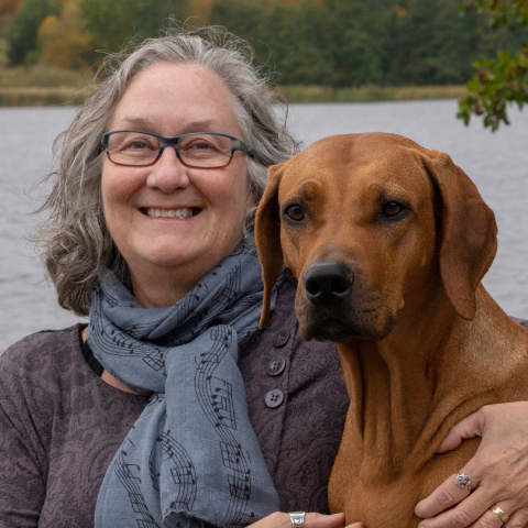 a person with a dog posing for the camera