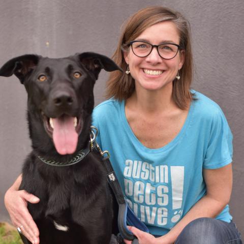 A woman with a dog posing for the camera